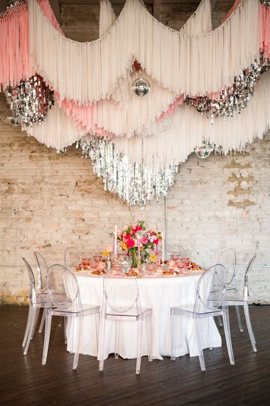 Table with a feast and ceiling fringe installation