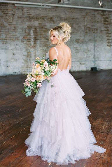 Bride looking over her shoulder with bouquet