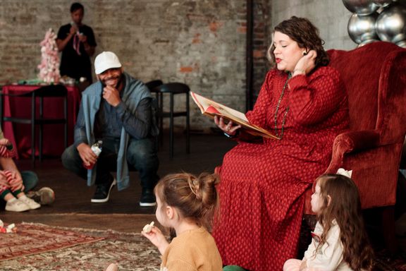 Woman reads book to kids