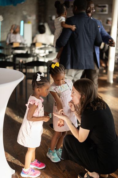 Woman talking enthusiastically with two little kids